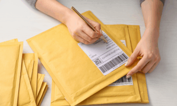 A woman writing on envelopes for blog post envelope stuffing jobs