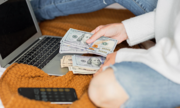 Woman counting cash as she needed to get paid today